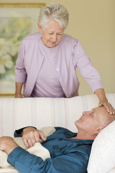 senior woman caring for her sick husband