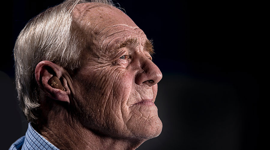 an elderly man wearing a hearing aid