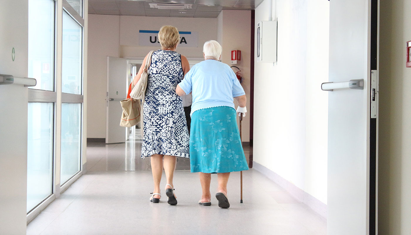 Woman accompanying her mother inside the building facility