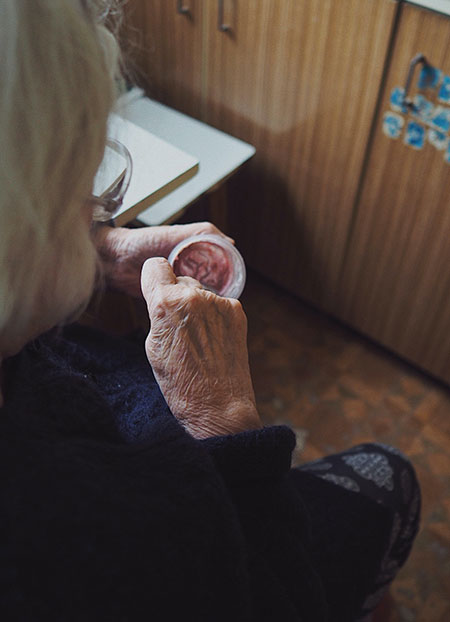 elderly person eating inside the room