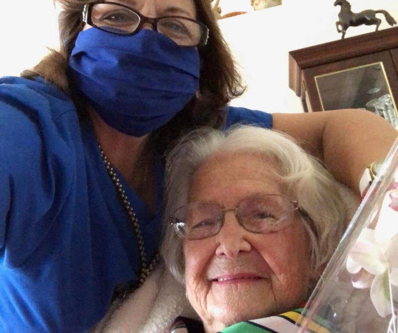 caregiver giving an elderly individual a bath cleaning