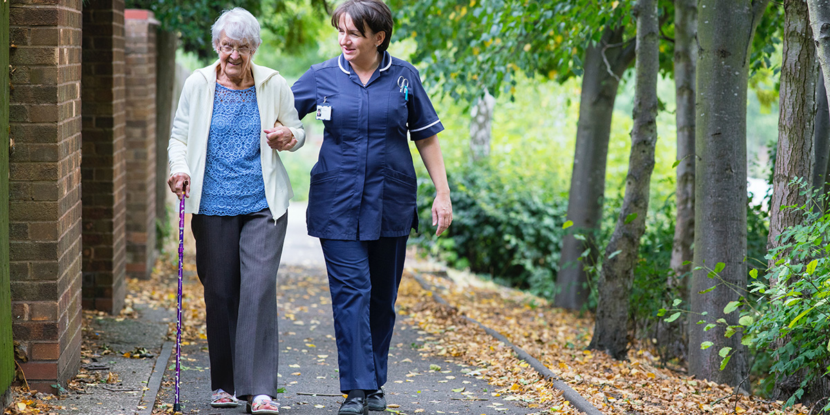 caregiver accompanying a female elderly