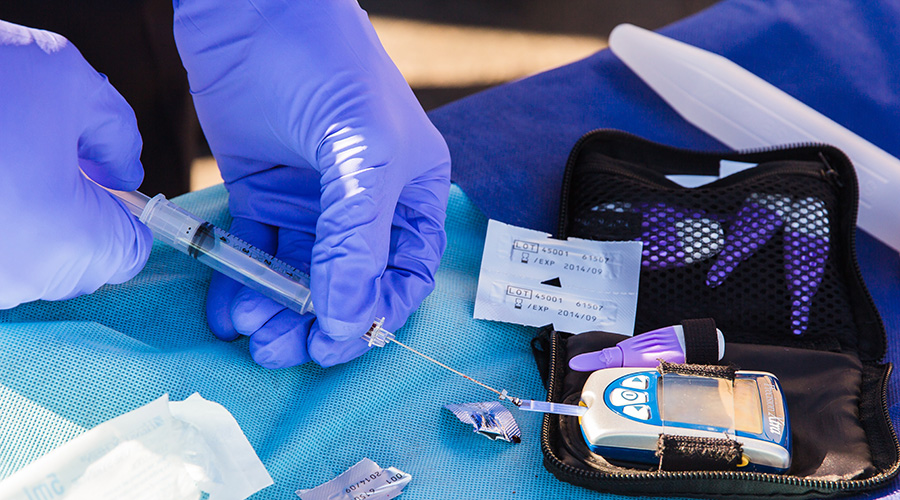 healthcare worker doing blood sugar test