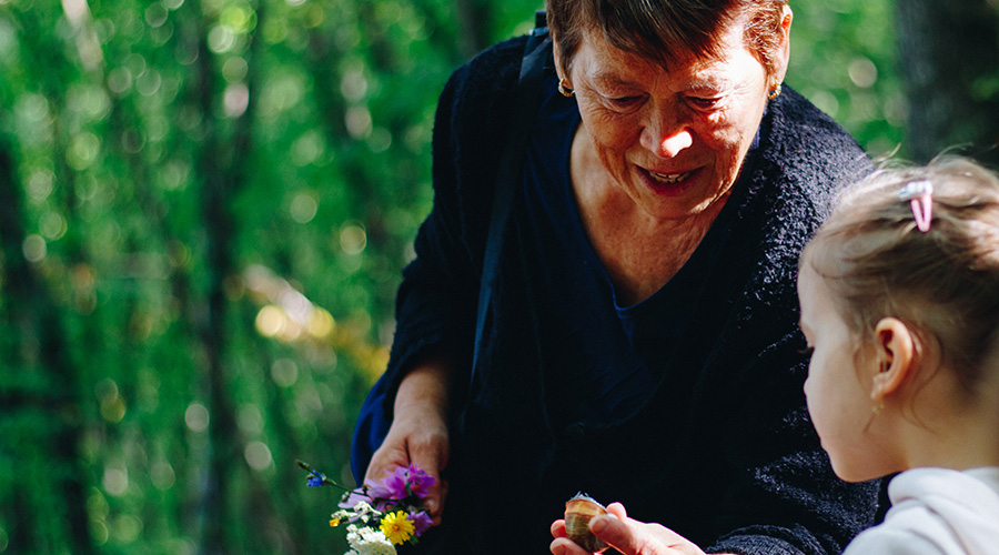 an elderly woman playing with a small girl