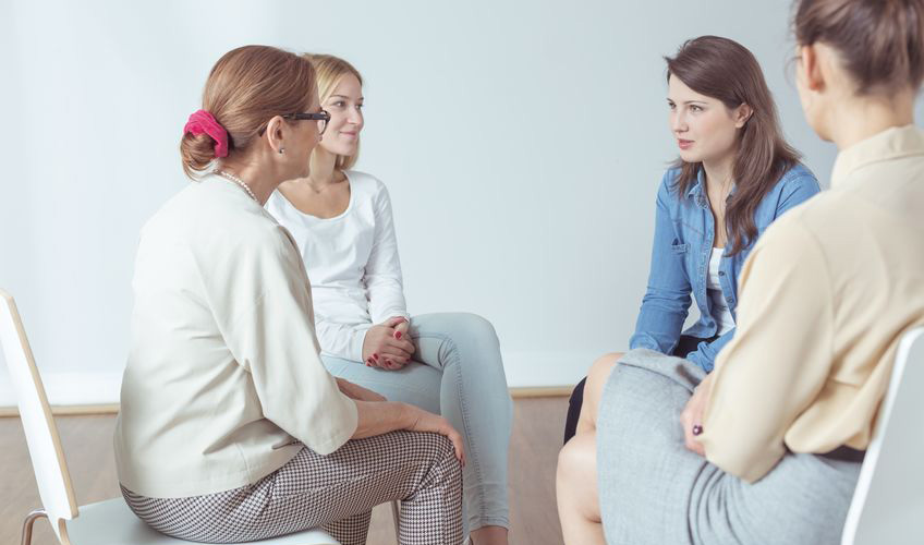 family member talking to a caregiver group