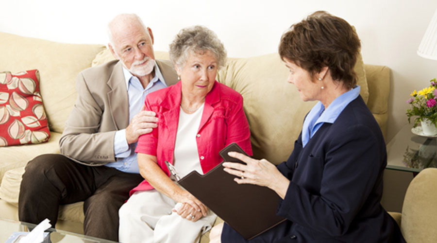 elderly couple consulting a senior care officer