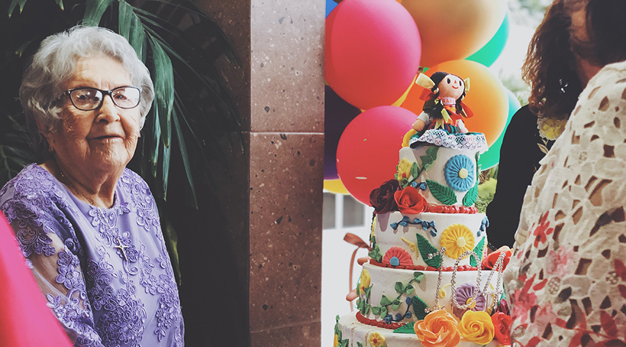 elderly senior celebrating with a cake