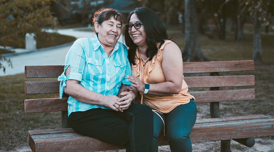 family caregiver with an elderly in the park