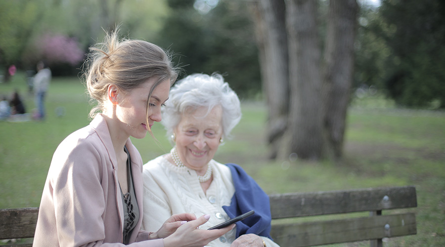 elderly woman and her caregiver enjoying at the park