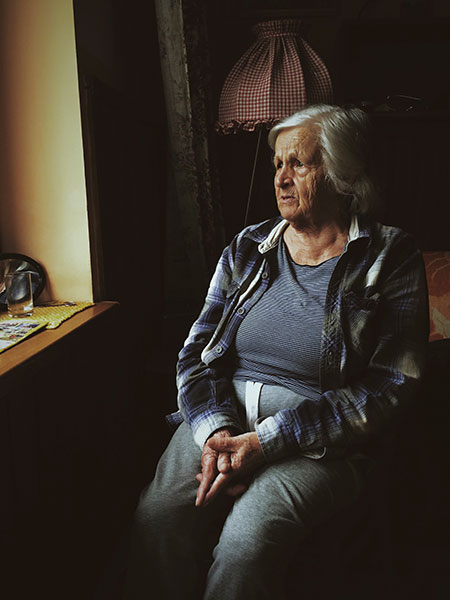an elderly woman staying alone inside the room