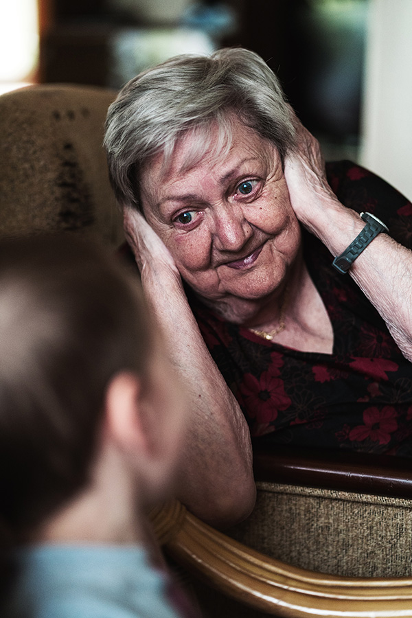 an elderly woman talking her caregiver