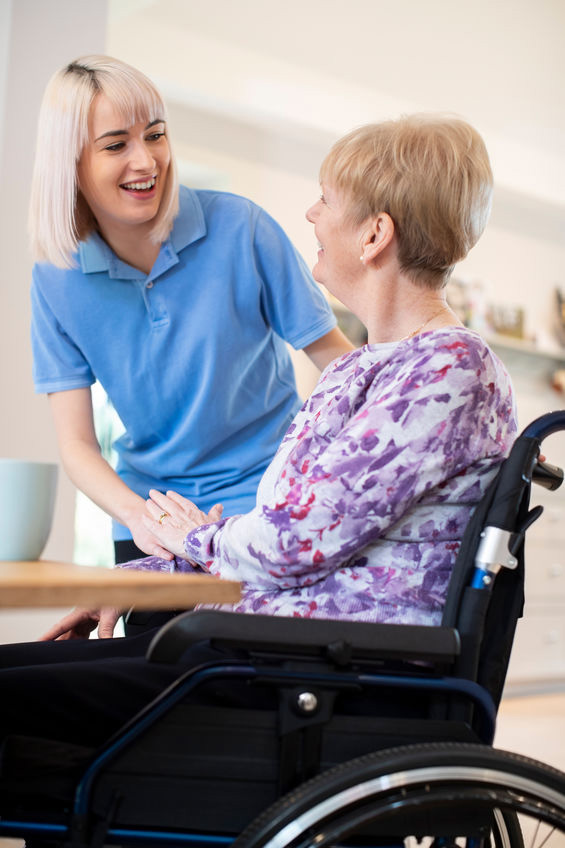 caregiver attending to an elderly in a wheelchair