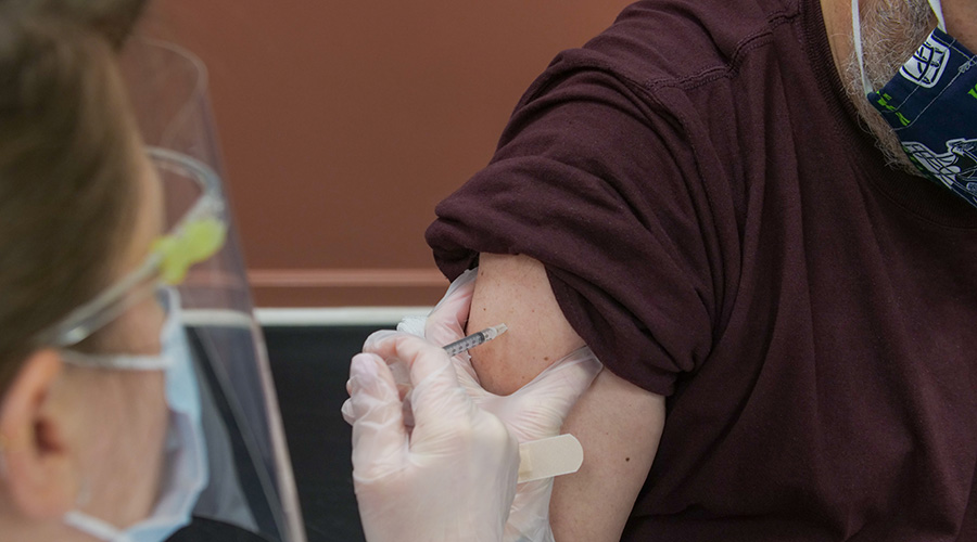 vaccine procedure being applied to an elderly