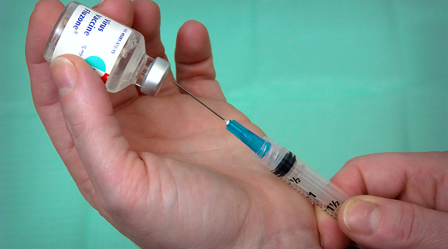 preparing the vaccine for injection