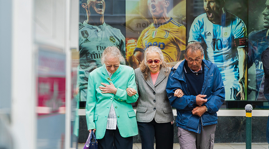 a group of elderly people walking together