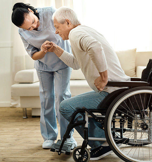 caregiver helping an elderly