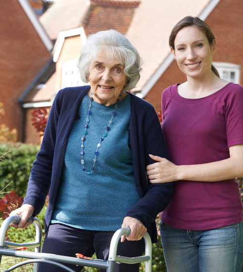 elderly woman accompanied by her family caregiver