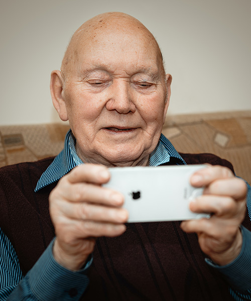 elderly man holding a mobile phone