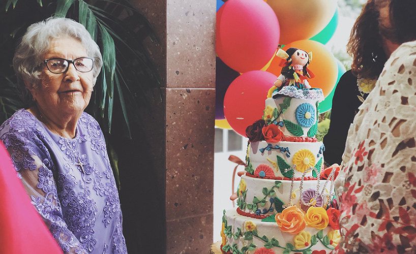 elderly senior celebrating with a cake