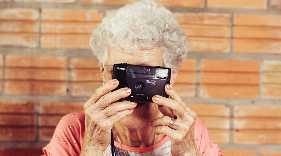 elderly senior playing with camera
