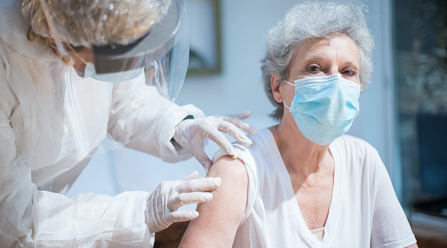elderly woman getting vaccinated