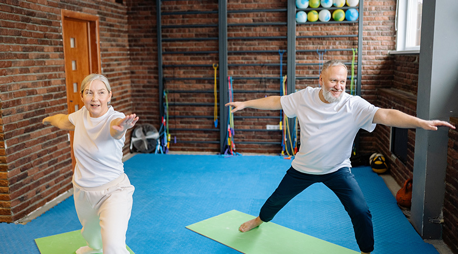 elderly couple doing exercises at the gym