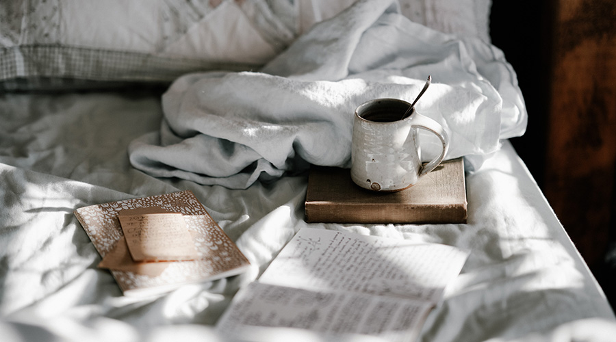 coffee and journal book in the bed