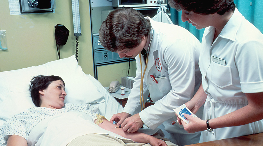 doctor and a nurse checking on a patient