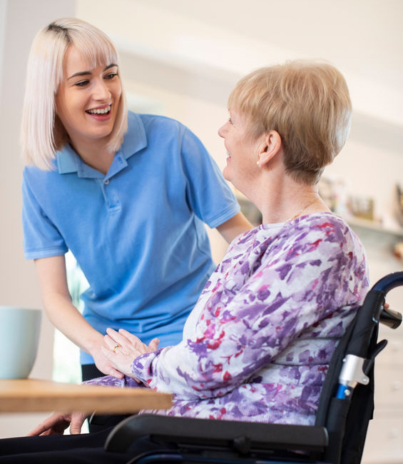 caregiver with an elderly in wheelchair