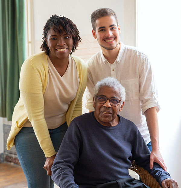 2 caregivers with an elderly in wheelchair
