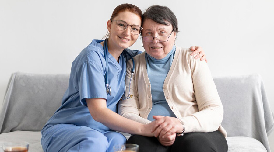 caregivers comforting senior woman