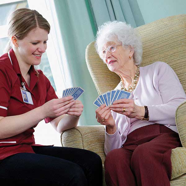 caregiver and client playing cards together