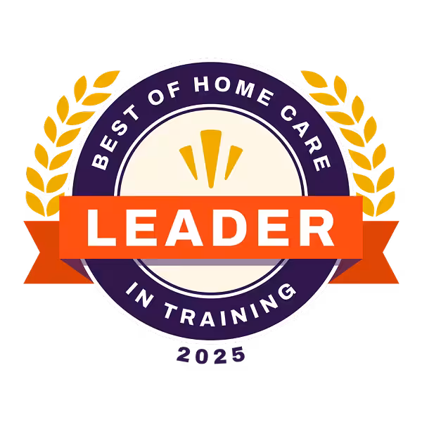 Circular badge with gold laurel leaves, a red banner reading LEADER, and the text Best of Home Care in Training 2025 in purple around the border, recognizing excellence in home care.