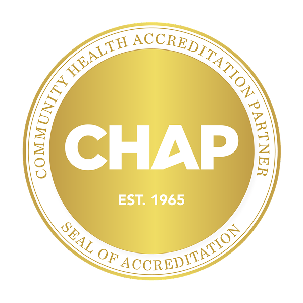 A gold circular seal with the words Community Health Accreditation Partner Seal of Accreditation around the edge and CHAP EST. 1965 in bold white letters in the center, symbolizing excellence in home care.